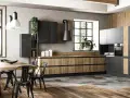 Cucina moderna con un accogliente stile industriale casa. Legno, metallo e cemento si fondono in un ambiente di design.