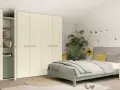 Camera da letto moderna con letto una piazza e mezza, armadio bianco e piante verdi.