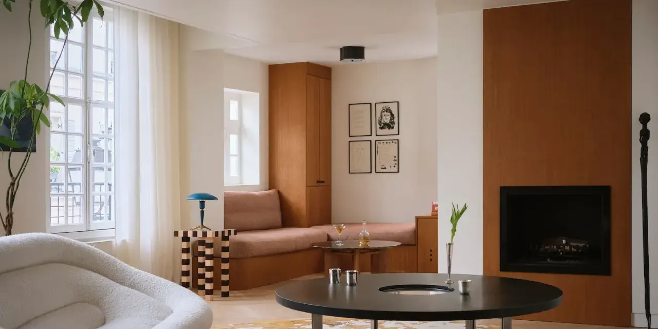 Un elegante soggiorno con un design **art deco interior design**, mobili in legno, un camino e una poltrona soffice.