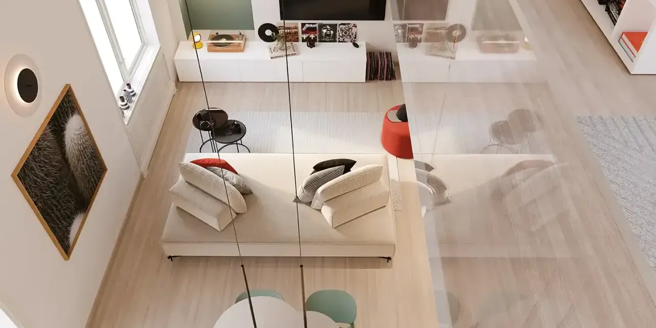 Arredamento soggiorno moderno con divano bianco, tavolino nero, quadro cactus e giradischi.