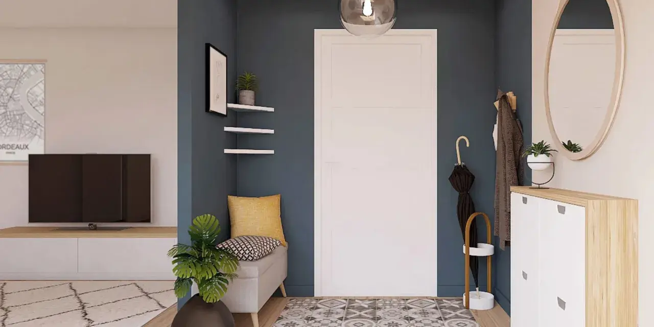 Ingresso accogliente con panca, specchio ovale e scarpiera bianca. Un tappeto geometrico e piante verdi completano le idee ingresso casa elegante.