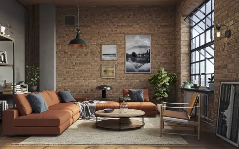 Soggiorno con divano arancione, tavolino rotondo e poltrona in legno. Pareti in mattoni a vista e grande finestra definiscono l'arredamento industrial chic.