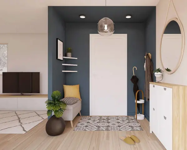 Ingresso accogliente con panca, specchio ovale e scarpiera bianca. Un tappeto geometrico e piante verdi completano le idee ingresso casa elegante.