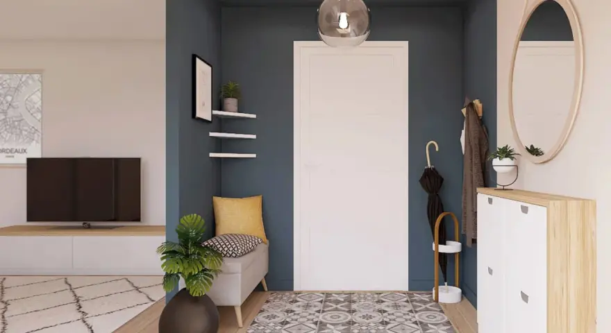 Ingresso accogliente con panca, specchio ovale e scarpiera bianca. Un tappeto geometrico e piante verdi completano le idee ingresso casa elegante.