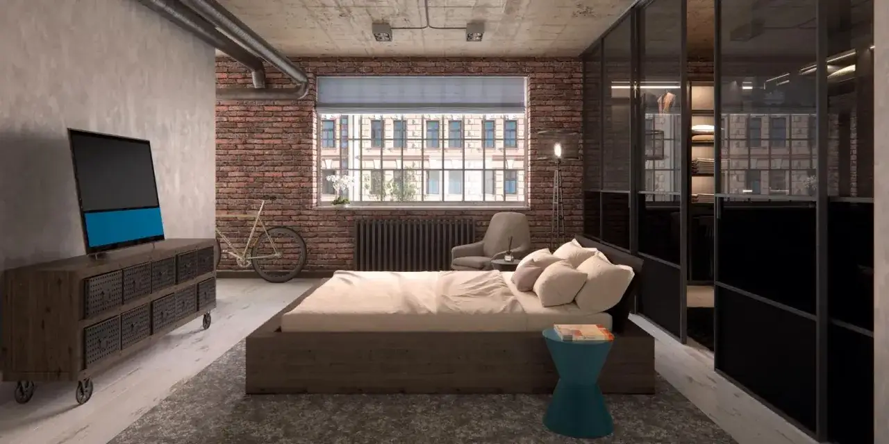 Camera da letto con un letto basso, un armadio a vista e una TV. Pareti in mattoni a vista e tubi a vista definiscono lo stile industriale casa.