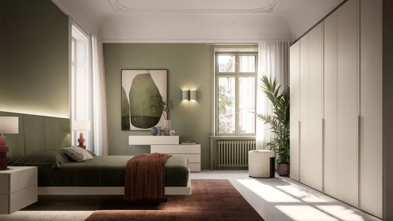 Camera da letto con pareti verdi e un letto accogliente. L'arredamento verde crea un'atmosfera rilassante, con un quadro astratto e un grande armadio bianco.