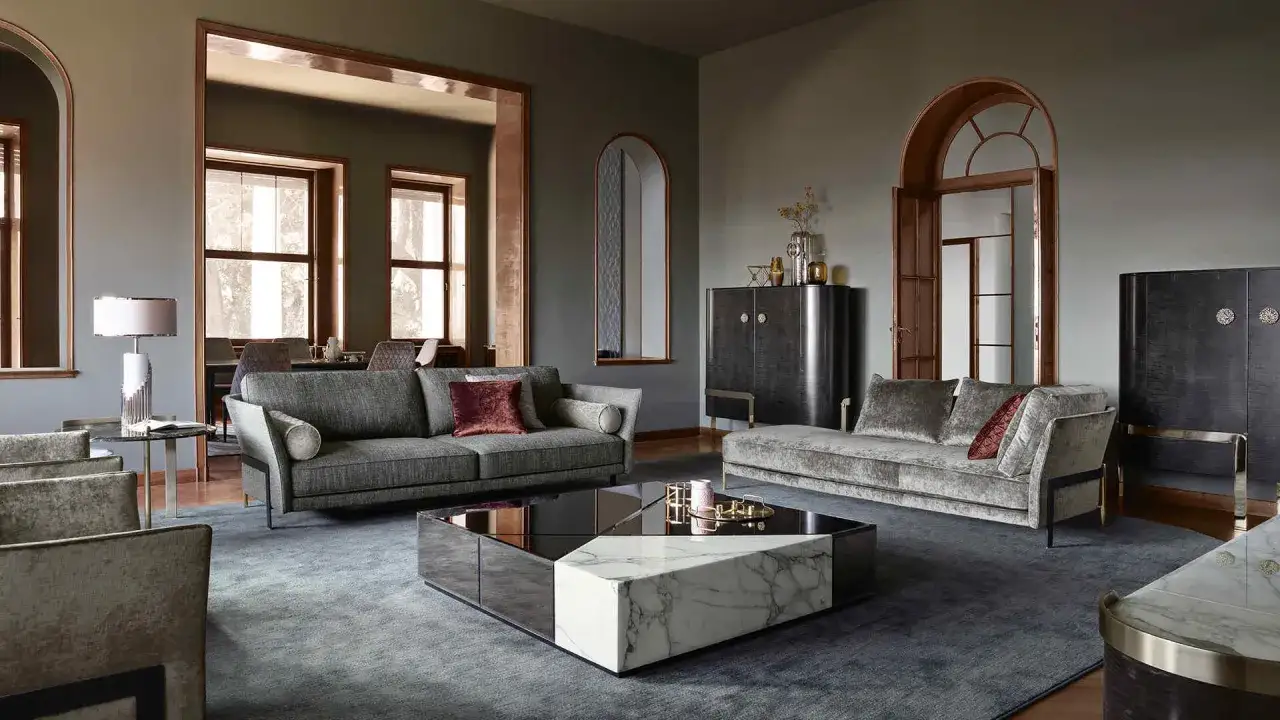 Elegante soggiorno in una casa stile moderno contemporaneo, con divani in velluto, tavolino in marmo e specchi.